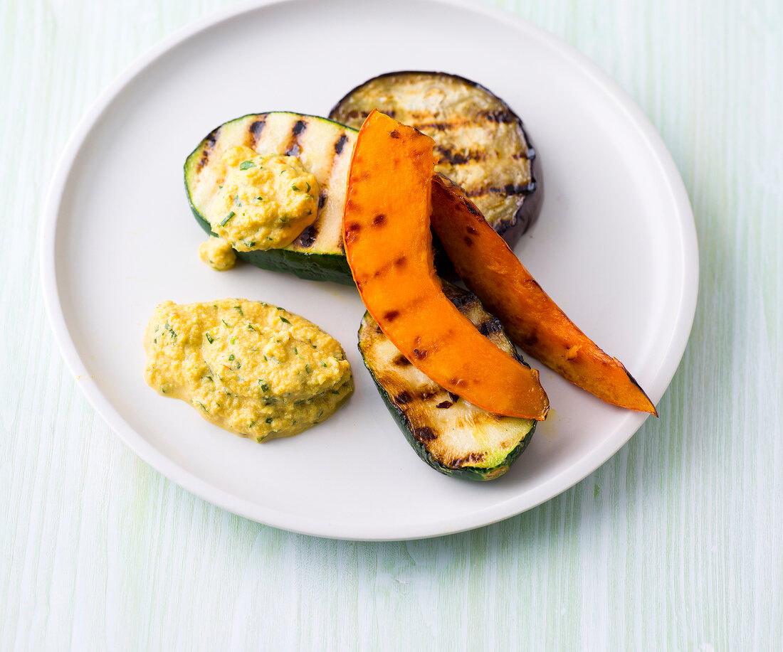 Grilled vegetables with Spanish and almond sauce on plate