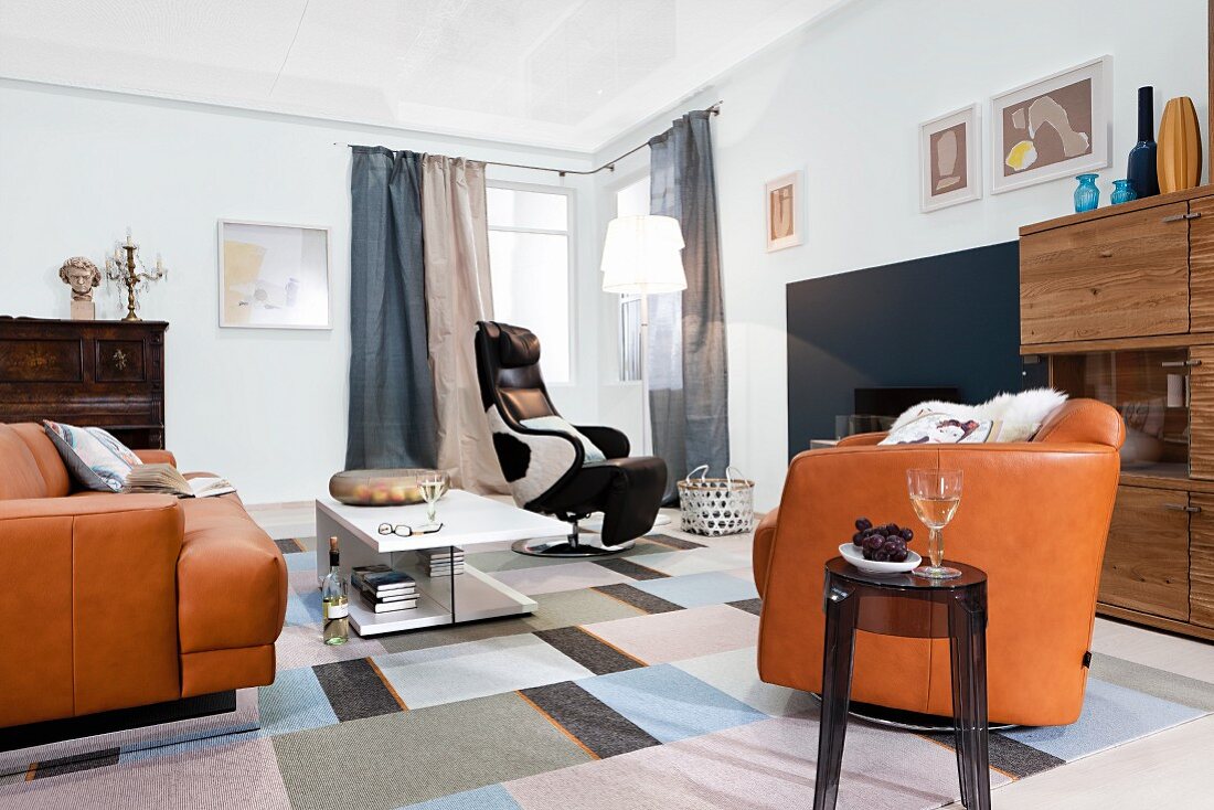 Living room with leather sofa set and cowhide-look recliner armchair