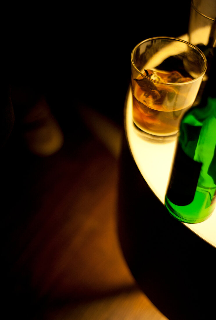 Drinks and bottles on illuminated table