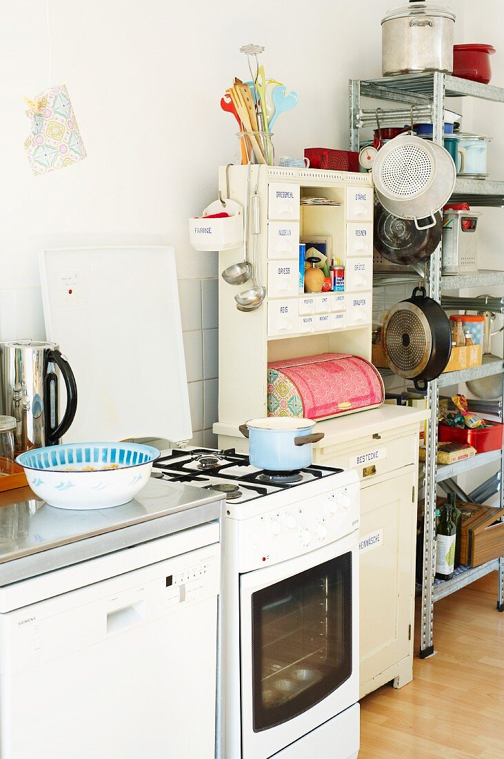 Cooker & utensils on shelves in students' kitchen