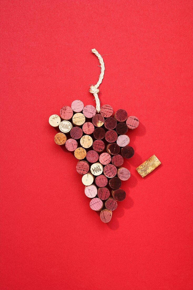Wine bottle corks arranged in the shape of a bunch of grapes