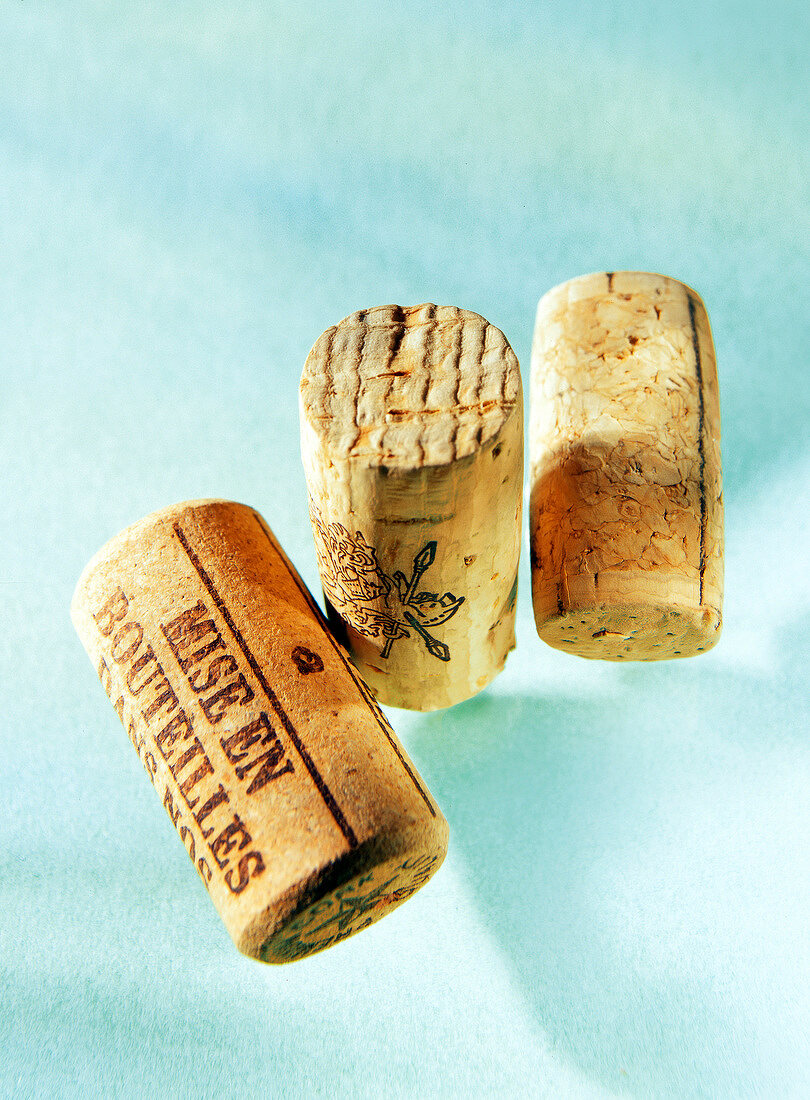 Close-up of three corks on blue background