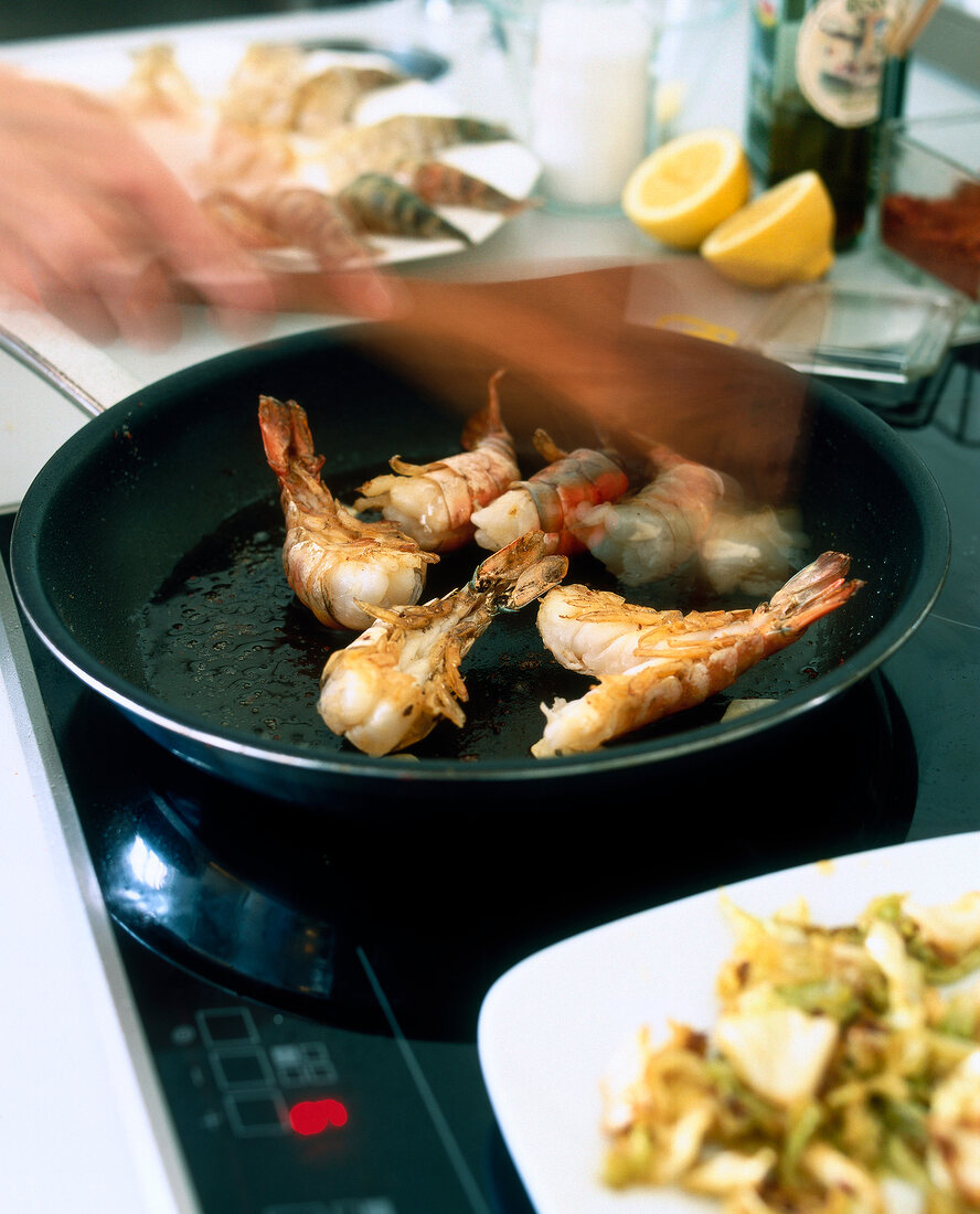 Shrimps being cooked on pan