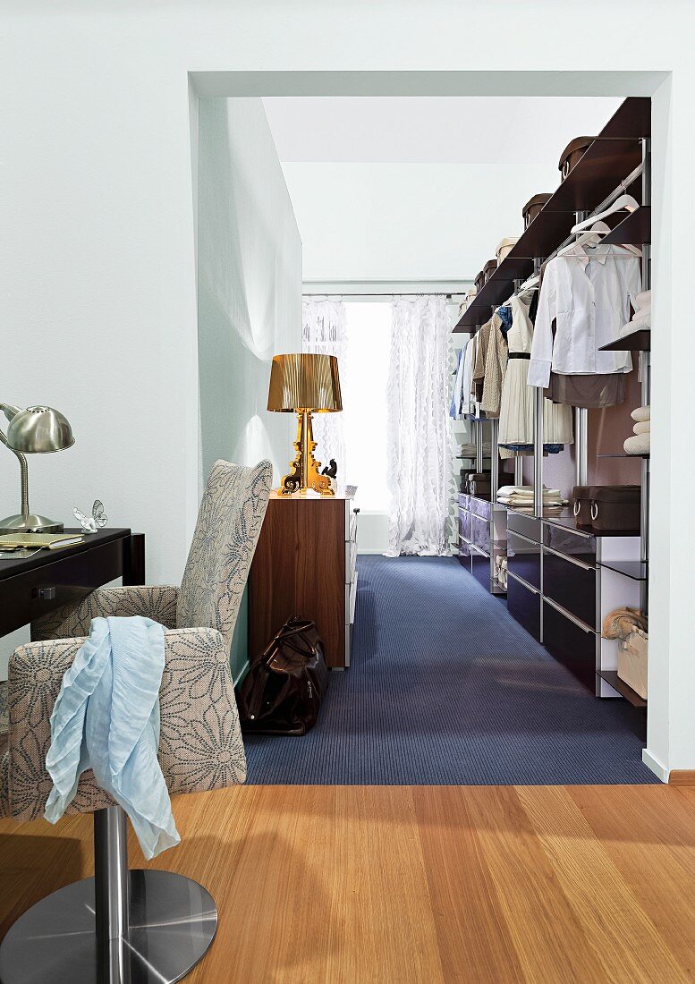 View from bedroom into dressing room with walk-in wardrobe & sideboard