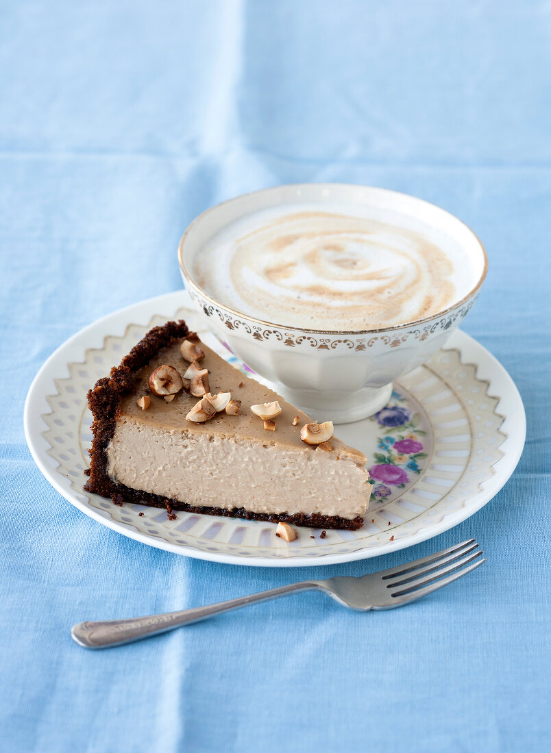 Hazelnut espresso cheese cake and cup of coffee on plate