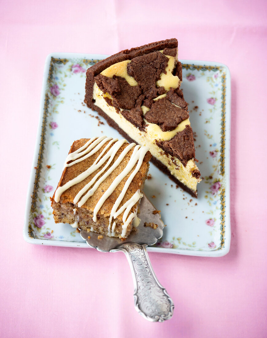 Pieces of Russian zupfkuchen with cottage cheese and nut cake on plate 