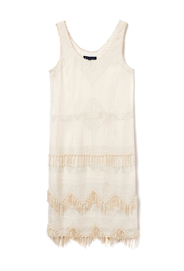 Close-up of white fringe dress on white background