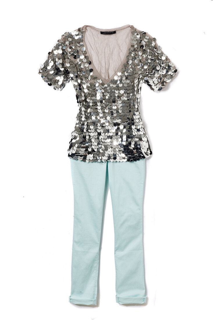 Silver pailletten top with blue pants on white background