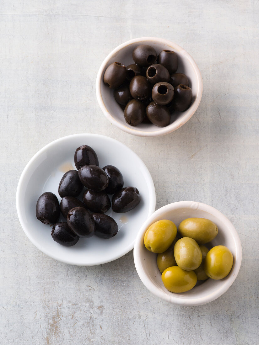 Green and black olives in bowls