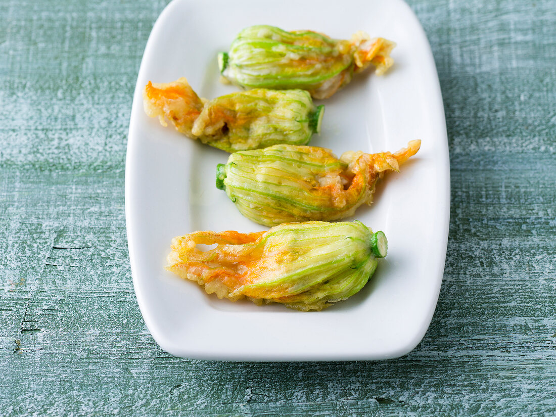 Stuffed courgette flowers in serving dish