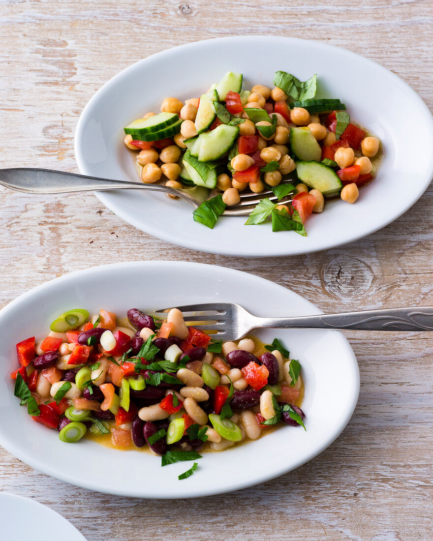 Chickpea salad and bean salad on plates