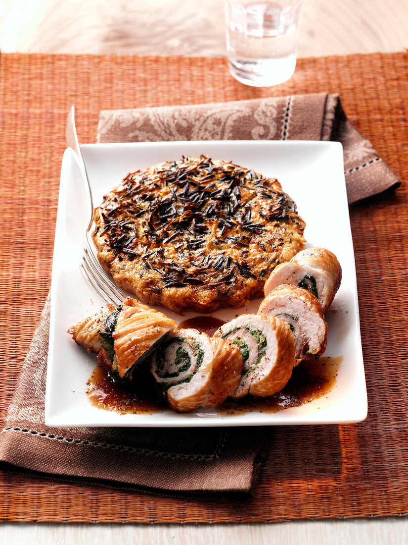 Turkey roulade with wild rice on plate