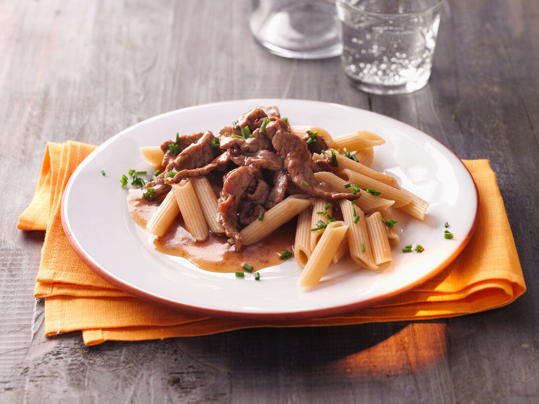 Veal with spelt penne on plate