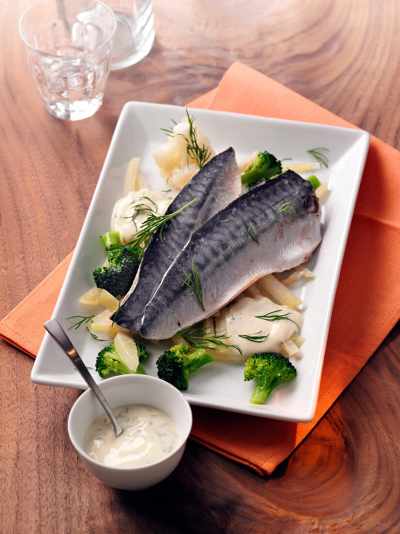 Mackerel with broccoli and dill on plate