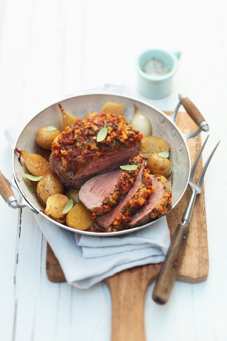 Lamb topside with a herb and tomato crust and shallots