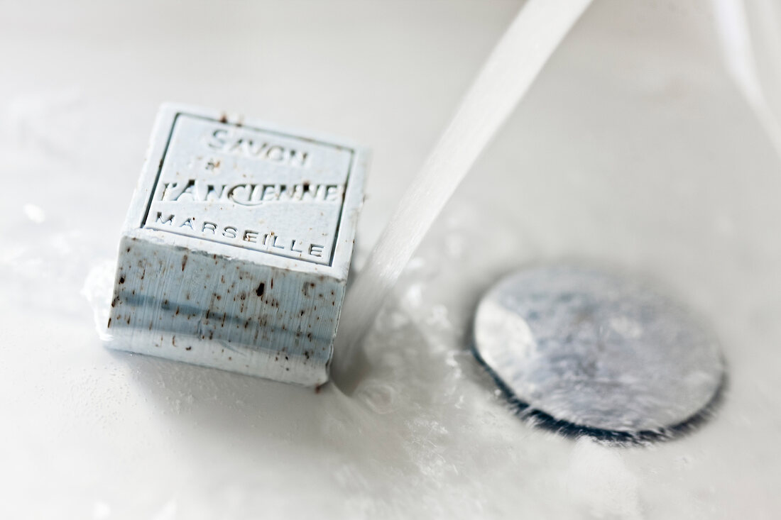 Close-up of square soap bar melting in water