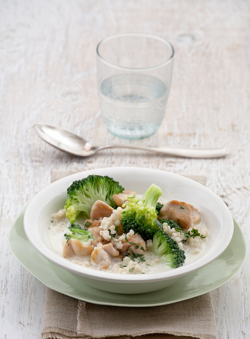 Pearl barley with broccoli and poularde in serving bowl