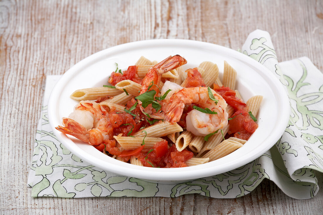 Penne with shrimp scampi in serving dish