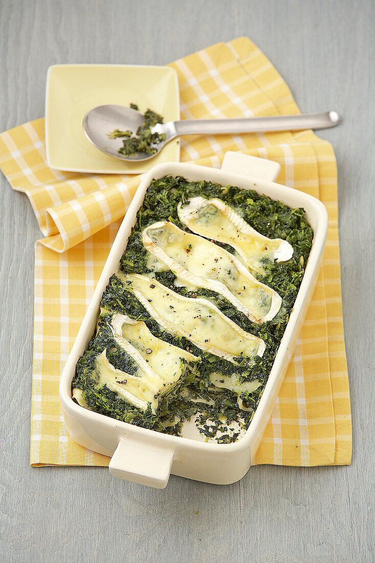 Kale with lasagne and cheese in serving dish
