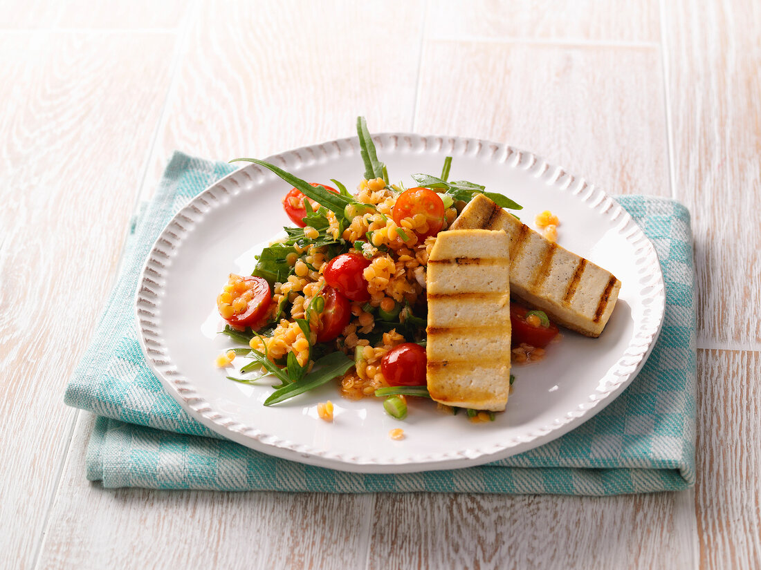 Red lentils salad with halloumi on plate