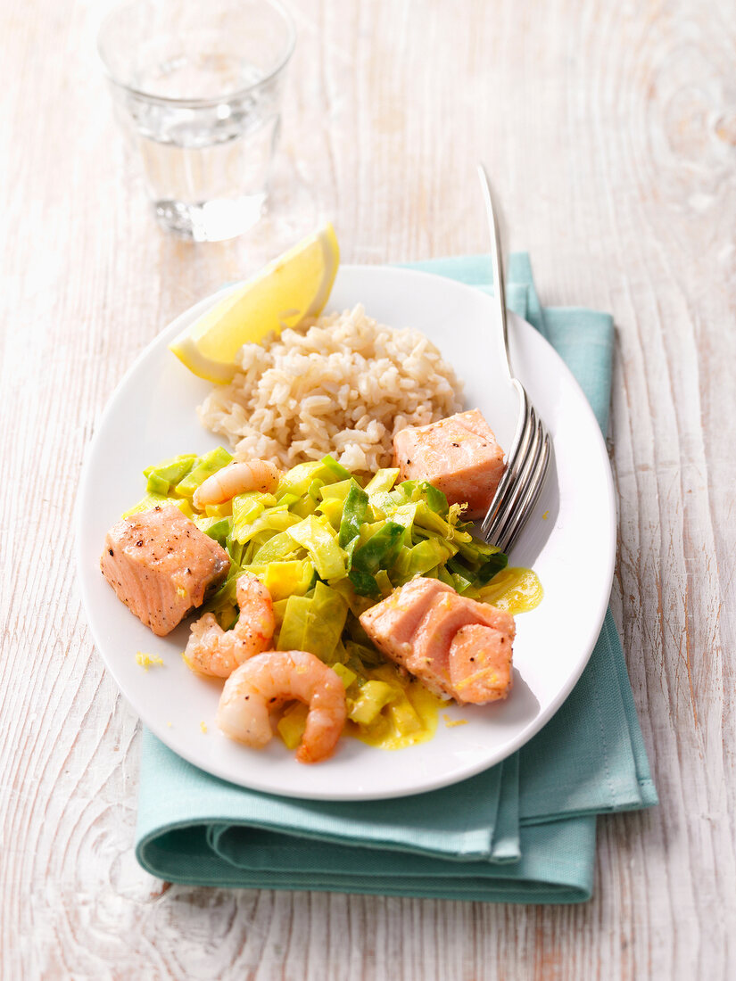 Salmon and shrimp with curry cabbage on plate