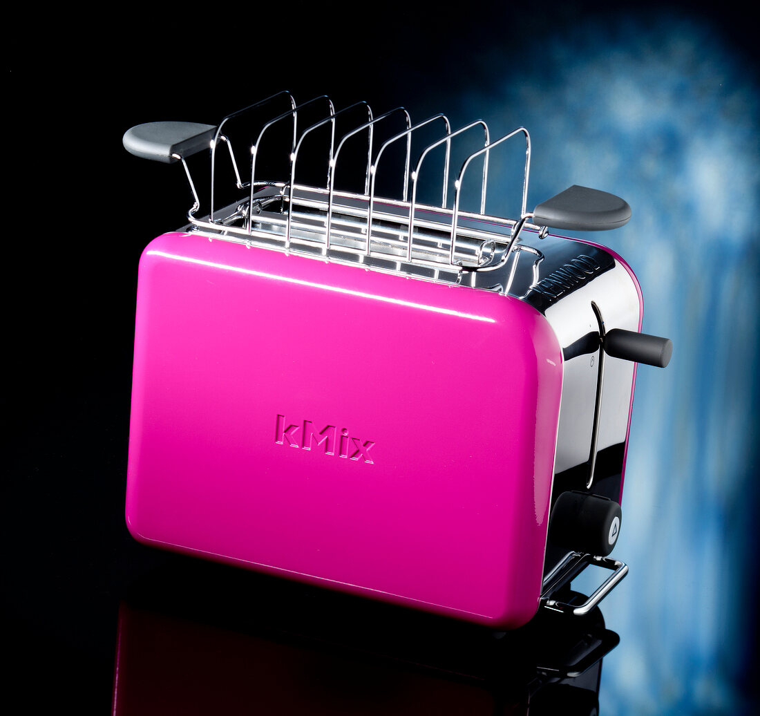 Pink toaster on black background