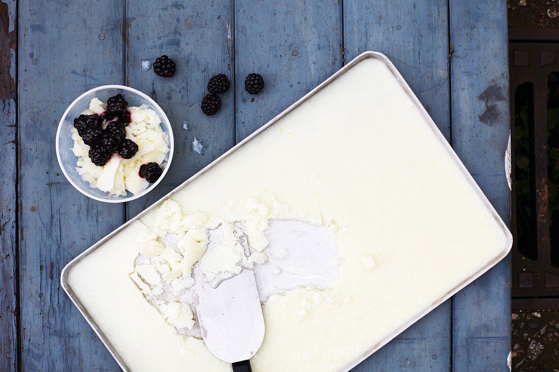 Homemade buttermilk ice cream on a tray with blackberries