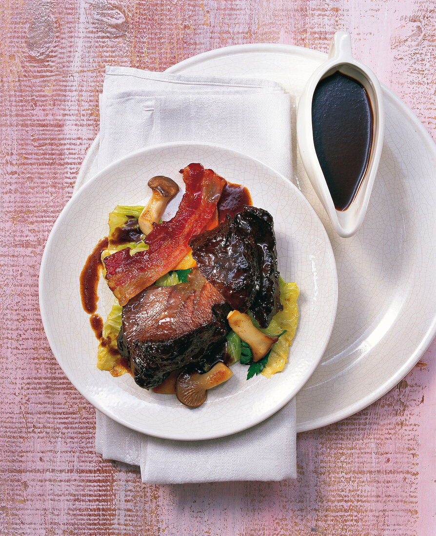 Braised beef cheeks with oyster mushrooms on plate