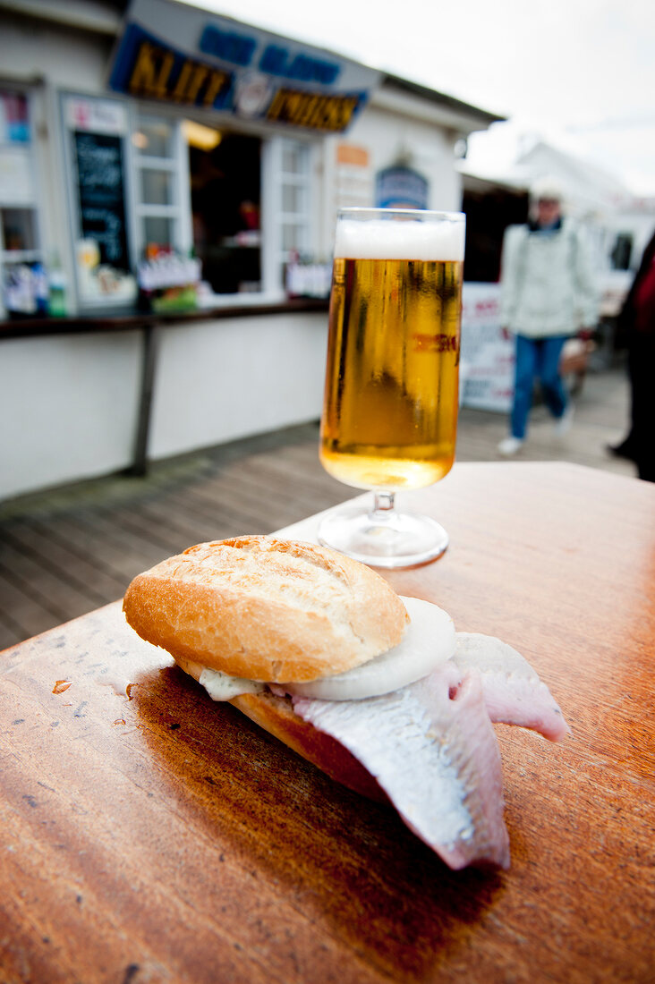 Close-up of pickled herring sandwiches and beer at Gosch Westerland