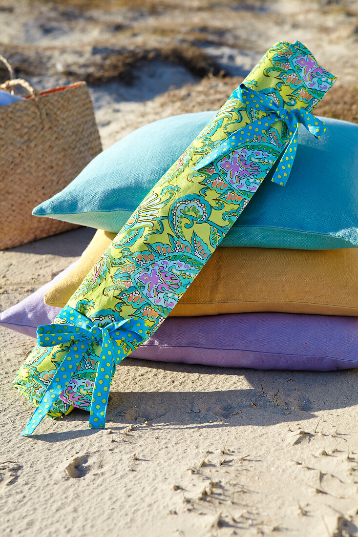 Picnic blanket curled up and tied at beach