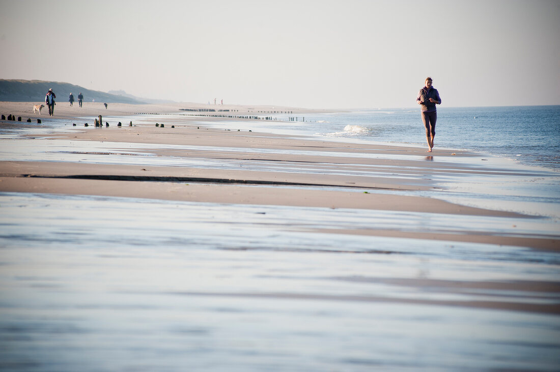 Joggers at beach of Westerland, Germany