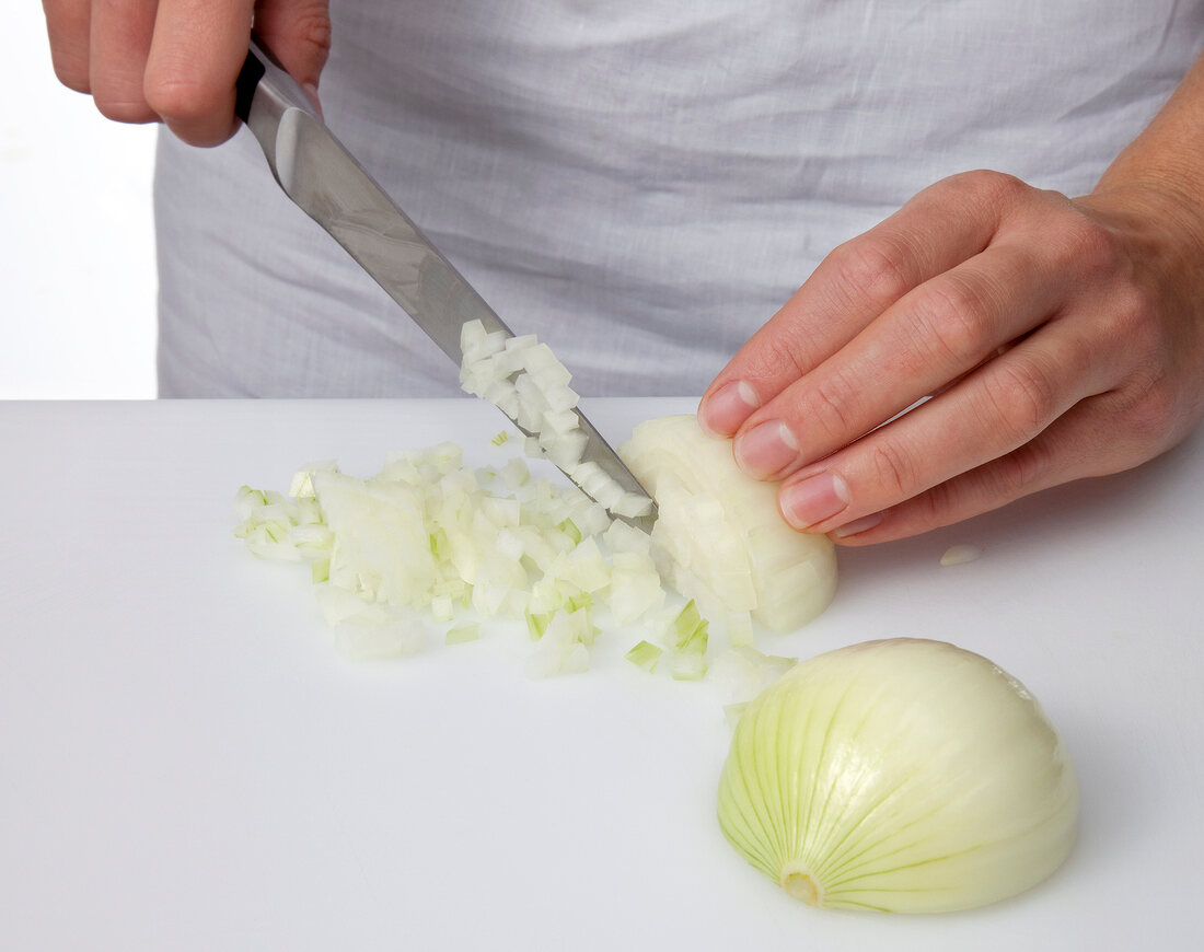 Peeled onions being finely chopped