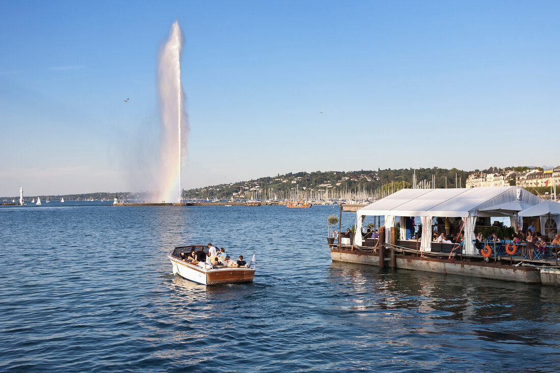 View of Jet d'eau fountain with boat in Jardin Anglais, Lake Geneva, Switzerland
