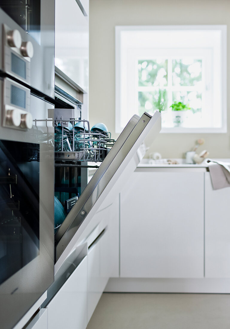 Open dishwasher with dishes in it