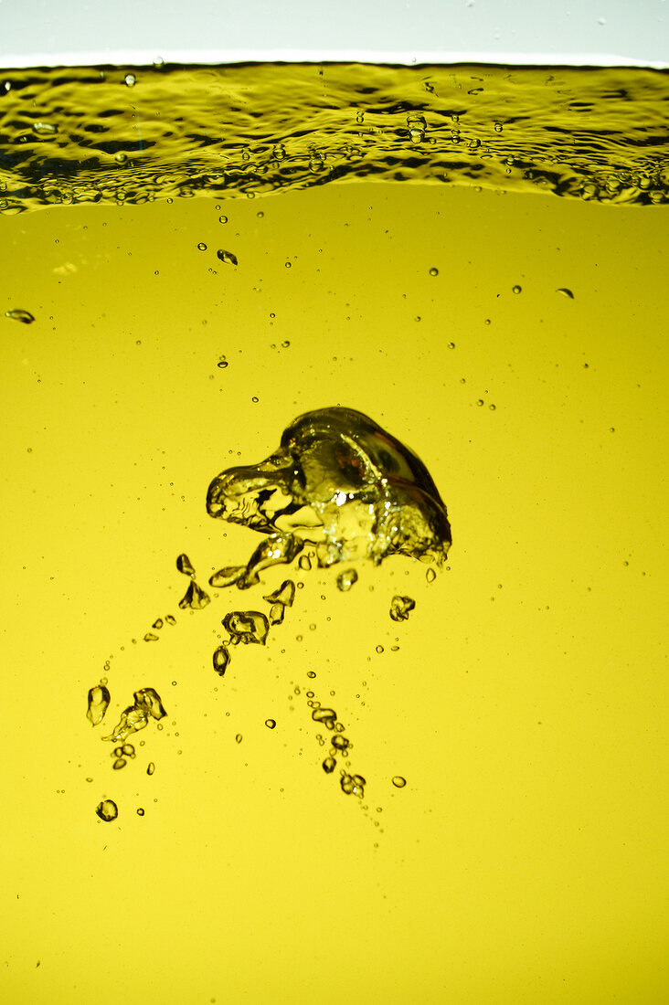 Close-up of olive oil with bubbles in it