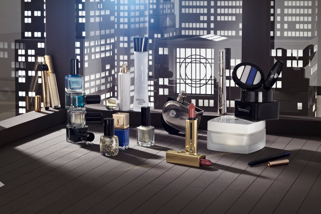 Various cosmetic products compiled against city skyscrapers