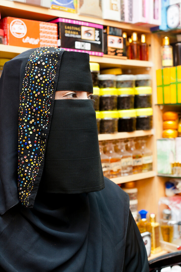 Close-up of woman wearing burka selling perfumes in Oman