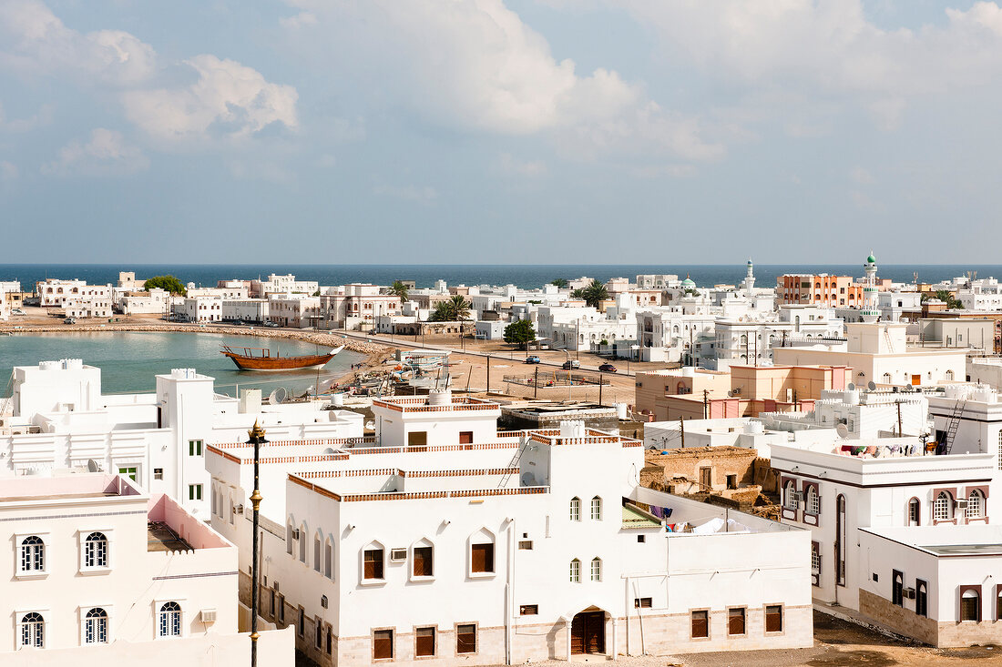 View of town with houses and harbour in Sur, Oman