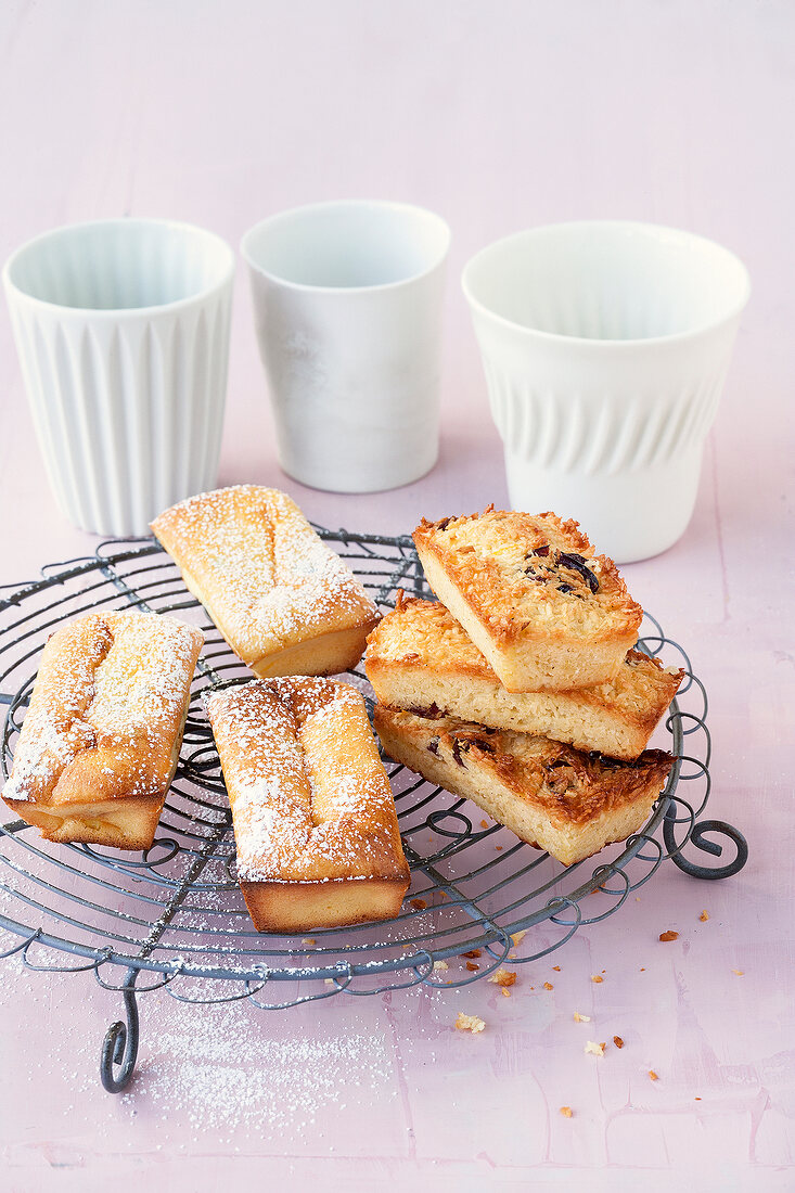 Coconut cakes and ricotta cakes on cake rack