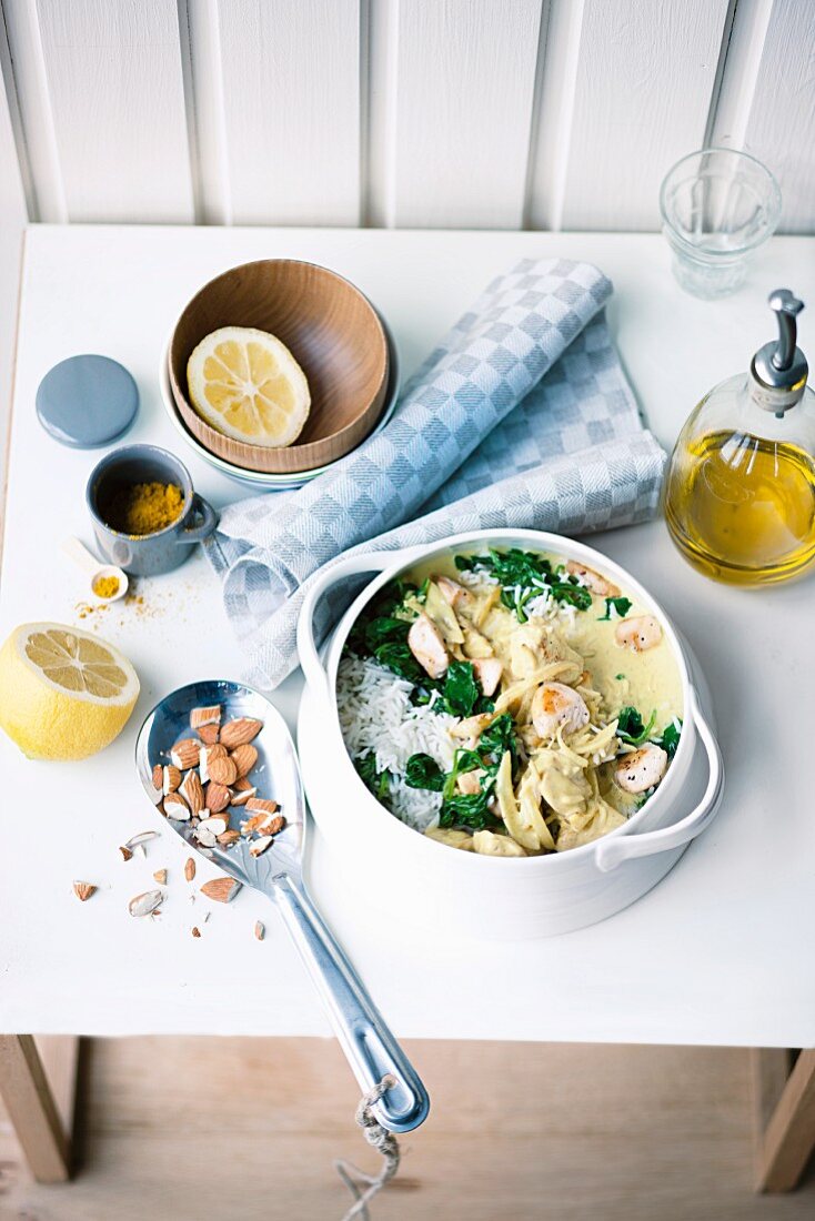 Chicken in a coconut and curry sauce with spinach, rice and almonds