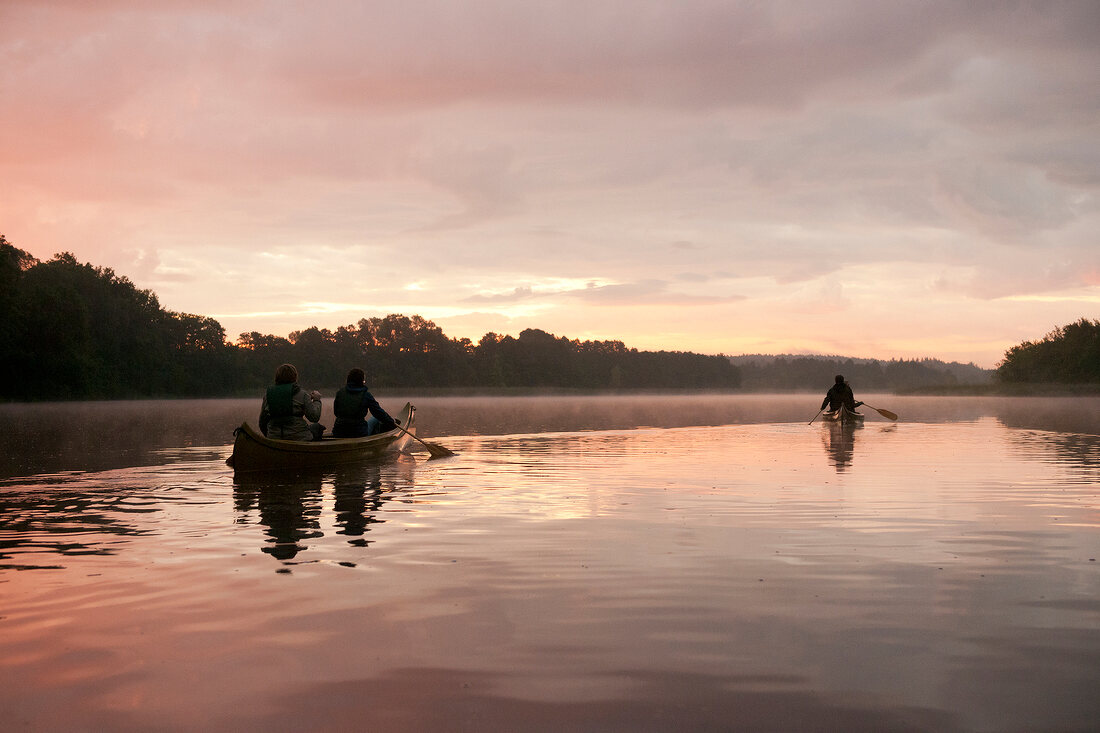 People sailing canoe in lake, Bradenburg, Germany