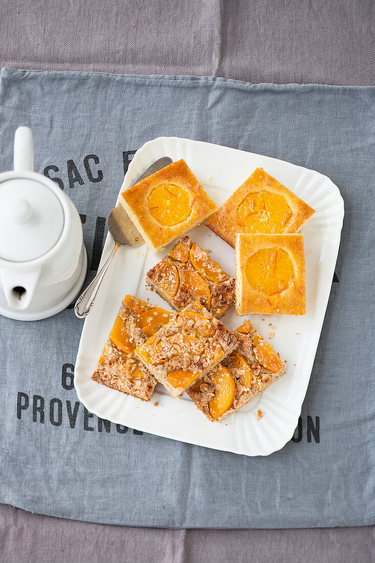 Sliced orange and peach sheet cake on plate