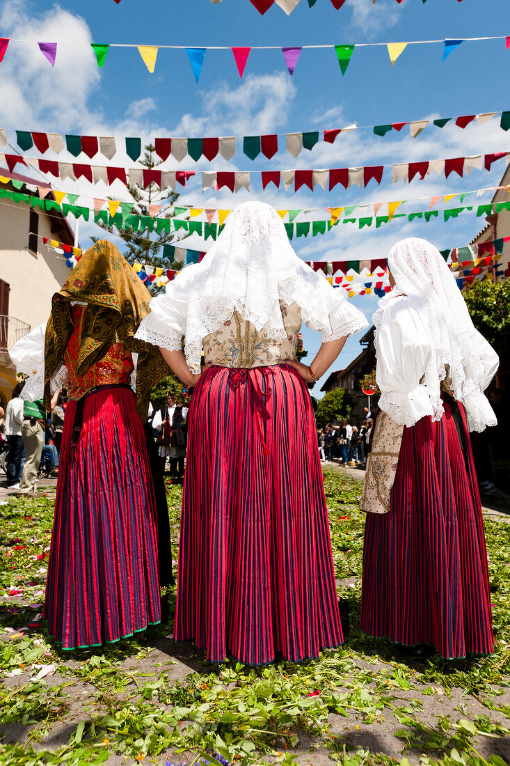 Three woman in costume for procession of Sant 'Efisio in Sardinia, Italy