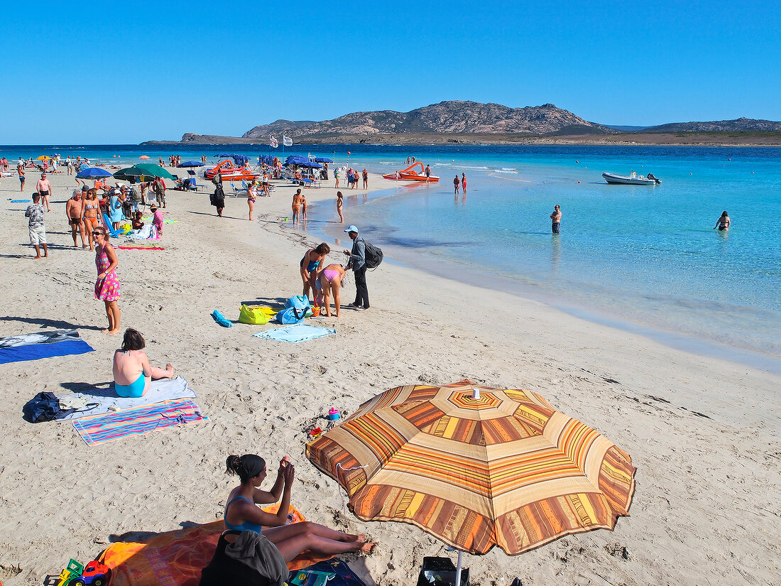 People enjoying at Spiaggia Della Pelosa, Stintino peninsula, Sardinia, Italy