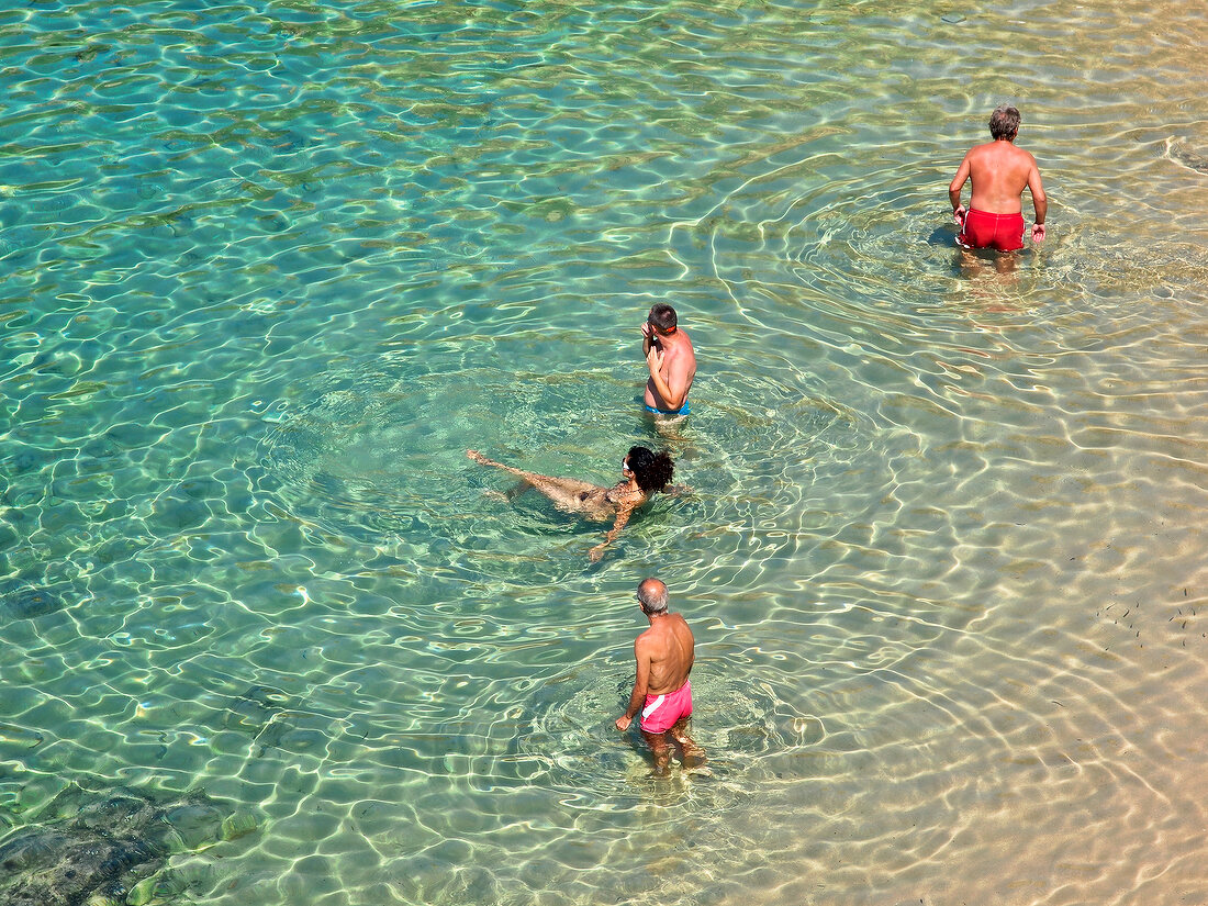 People enjoying in water at Costa Paradiso at North Coast of Sardinia, Italy