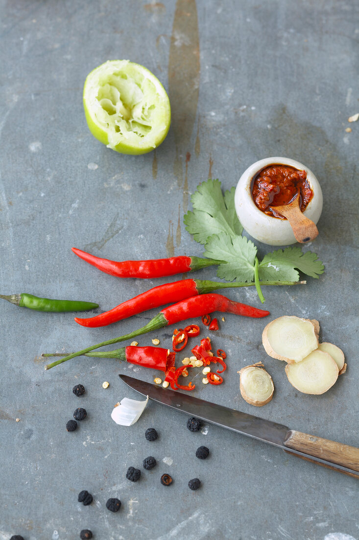 Coriander, garlic, chilli, lime and ginger with knife