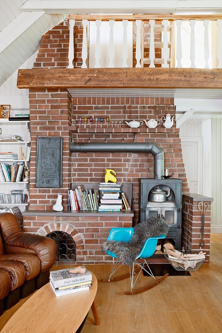 Wood-burning stove against brick wall in country-house living room