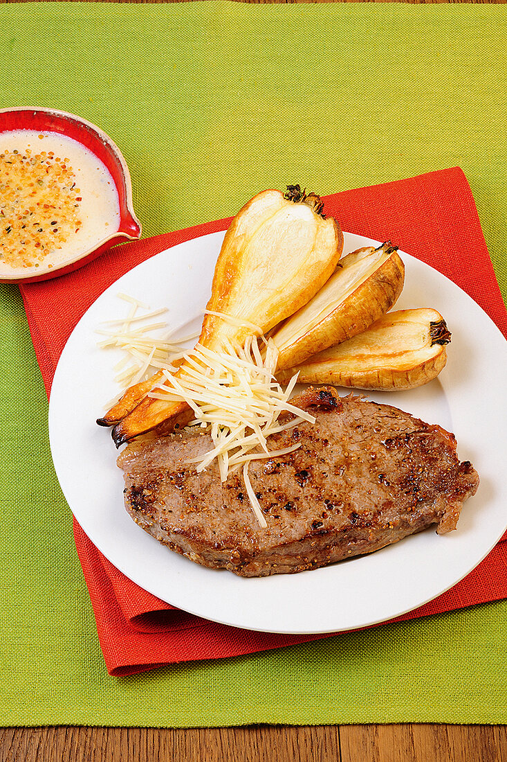 Rump steak with fried parsnip on plate