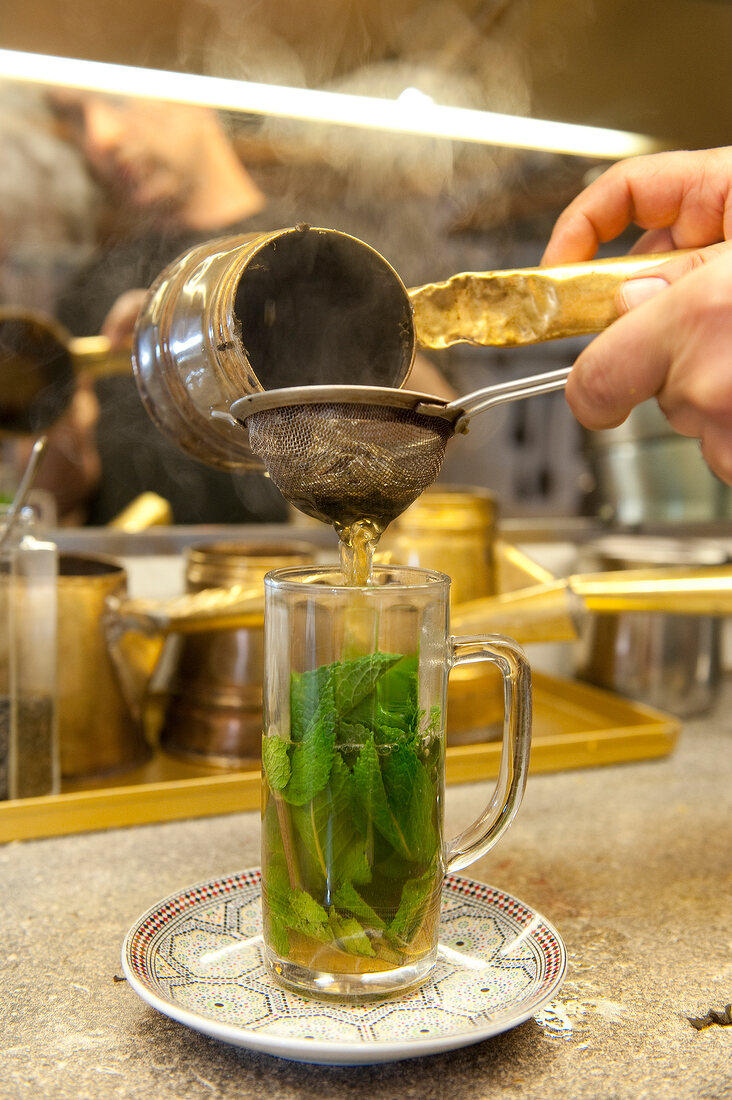 Mint tea in poured in glass, local Casablanca, Cologne calk district