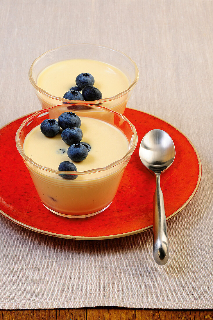 Two mascarpone panna cotta with cherries in glass